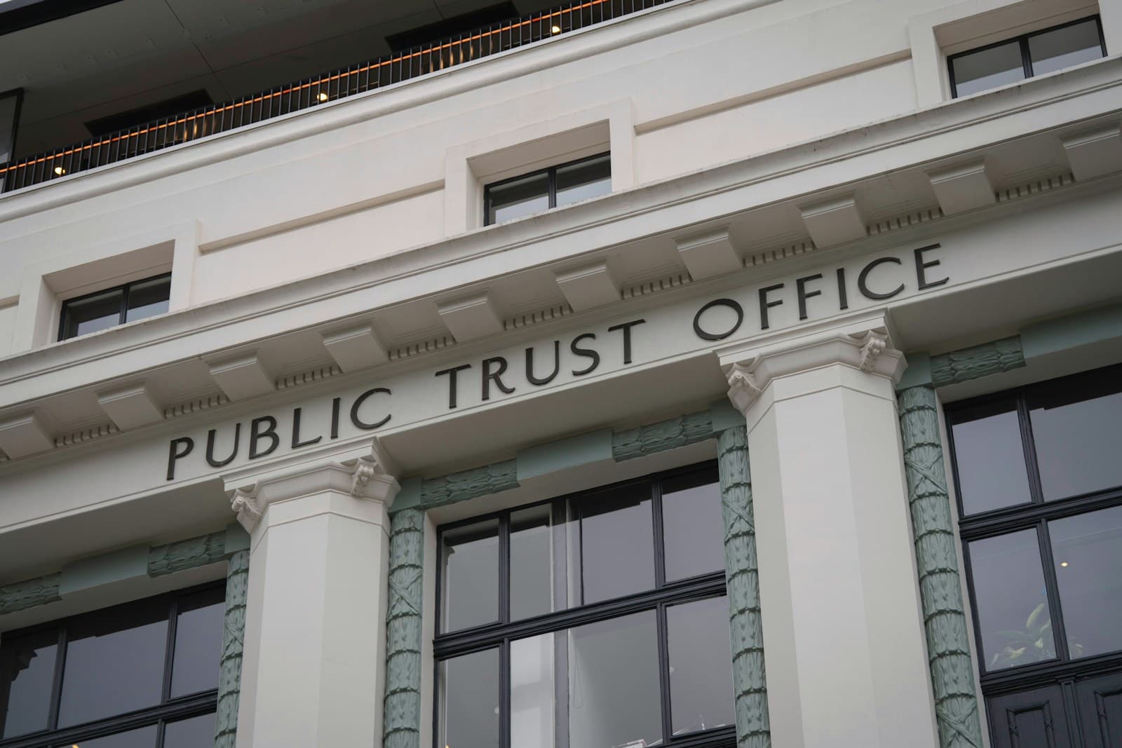 The stone facade of a public office building with tall columns and rows of windows